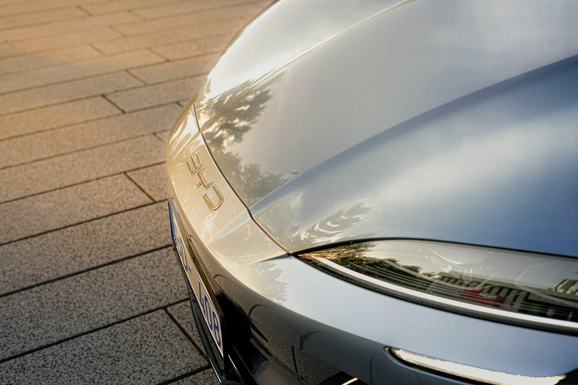 Glossy, freshly detailed vehicle hood with mirror-like reflections