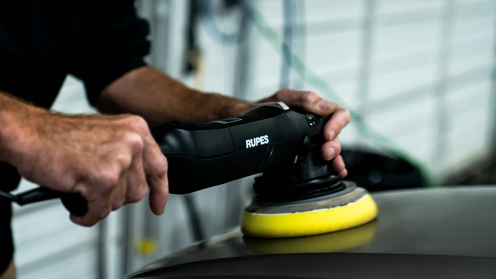 Detailer machine polishing a vehicle panel